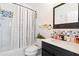 Clean bathroom with a shower/tub combo, patterned tile and dark vanity at 418 Water St, Kissimmee, FL 34747