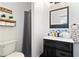 Clean bathroom with dark vanity, white countertop, and blue and white tile at 418 Water St, Kissimmee, FL 34747