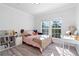 Bright bedroom with a pink and leopard print bedding set and a built-in desk at 418 Water St, Kissimmee, FL 34747