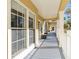 Shared covered patio with light colored flooring and white railings at 418 Water St, Kissimmee, FL 34747