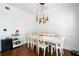 Bright dining room with white table and chairs, hardwood floors, and a modern chandelier at 418 Water St, Kissimmee, FL 34747