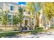 Tan two-story townhouses with mature trees and manicured landscaping at 418 Water St, Kissimmee, FL 34747