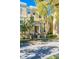 Tan townhome with front steps, landscaping, and tree-lined street at 418 Water St, Kissimmee, FL 34747