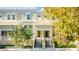 Two story tan townhome with a front porch and stairs at 418 Water St, Kissimmee, FL 34747