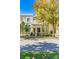 Two story tan townhome with front porch and lush landscaping at 418 Water St, Kissimmee, FL 34747