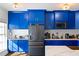 Blue kitchen with stainless steel appliances and marble countertops at 418 Water St, Kissimmee, FL 34747