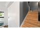 Staircase with light wood steps and dark gray wall at 418 Water St, Kissimmee, FL 34747