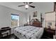 Spacious bedroom with a king-size bed, large window, and dark wood furniture at 8279 Nemours Pkwy, Orlando, FL 32827
