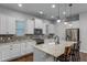 Spacious kitchen with white cabinets, granite countertops, and stainless steel appliances at 8279 Nemours Pkwy, Orlando, FL 32827