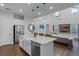Open concept kitchen with large island, white cabinets, and farmhouse sink at 8279 Nemours Pkwy, Orlando, FL 32827