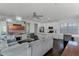 Modern kitchen with white cabinets, a large island, and dark hardwood floors at 8279 Nemours Pkwy, Orlando, FL 32827