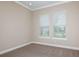 Bright bedroom with neutral walls and carpeting, two windows with blinds at 857 Arbor Green Trl, Saint Cloud, FL 34771