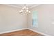Formal dining room with wood-look floors and elegant chandelier at 857 Arbor Green Trl, St Cloud, FL 34771