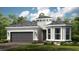 Single-story home with gray roof, attached garage, and landscaping at 857 Arbor Green Trl, St Cloud, FL 34771