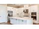 Spacious kitchen with white cabinets, stainless steel appliances, and large island at 857 Arbor Green Trl, St Cloud, FL 34771