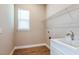 Laundry room with a sink, cabinetry, and overhead shelving at 857 Arbor Green Trl, St Cloud, FL 34771
