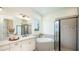 Spa-like bathroom with soaking tub, walk-in shower, and modern vanity at 919 Tassleflower Trl, St Cloud, FL 34771