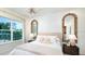 Bright bedroom with large windows, plush bed, and decorative mirrors at 919 Tassleflower Trl, Saint Cloud, FL 34771