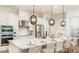 Kitchen features a large island with seating, white cabinets and stainless steel appliances at 919 Tassleflower Trl, St Cloud, FL 34771
