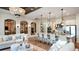 Open concept living room and kitchen with a large island and stylish light fixtures at 919 Tassleflower Trl, St Cloud, FL 34771