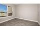 Bright bedroom with large window and wood-look flooring at 925 Tassleflower Trl, St Cloud, FL 34771
