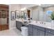 Elegant bathroom with dual vanities, large mirror, and a walk-in closet access at 932 Tassleflower Trl, Saint Cloud, FL 34771