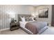Cozy bedroom with patterned wallpaper, a comfortable bed, and stylish nightstands at 932 Tassleflower Trl, Saint Cloud, FL 34771