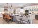 Modern white kitchen with gray island, stainless steel appliances, and seating for six at 932 Tassleflower Trl, Saint Cloud, FL 34771