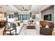 Welcoming living area with large windows, sliding doors, and plush white sectional sofa at 932 Tassleflower Trl, Saint Cloud, FL 34771