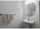 Small bathroom with pedestal sink, round mirror and white walls at 1058 Berkman Cir, Sanford, FL 32771