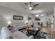 Spacious living room featuring light leather furniture and wood-style floors at 1058 Berkman Cir, Sanford, FL 32771