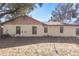 Rear view of a single-story house with a spacious backyard at 120 Trafalgar Pl, Longwood, FL 32779