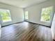 Spacious bedroom with large windows and wood-look flooring at 1202 Alafia Way, Poinciana, FL 34759