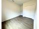 Well-lit bedroom with grey wood-look flooring and a double door closet at 1314 Hillsborough Ct, Poinciana, FL 34759