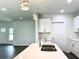 Modern kitchen with white cabinets, double sink, and island at 1314 Hillsborough Ct, Poinciana, FL 34759