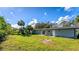 Large grassy backyard with a view of neighboring properties at 1545 Culverhouse Dr, Daytona Beach, FL 32117