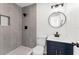 Modern bathroom with gray tile shower and navy vanity at 1545 Culverhouse Dr, Daytona Beach, FL 32117