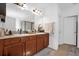 Double vanity bathroom with a large mirror and a separate shower at 1651 Kingfisher Ct, Kissimmee, FL 34746