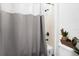 Clean bathroom with shower/tub combo and gray shower curtain at 1651 Kingfisher Ct, Kissimmee, FL 34746
