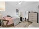 Cozy bedroom with a full-size bed, dresser, and full-length mirror at 1651 Kingfisher Ct, Kissimmee, FL 34746