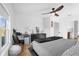 Bright bedroom with a queen-size bed, home office space, and large window at 1651 Kingfisher Ct, Kissimmee, FL 34746
