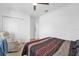 Comfortable bedroom with a bed, recliner, and double doors at 1651 Kingfisher Ct, Kissimmee, FL 34746