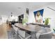 Bright dining room with large wood table and modern light fixture at 1651 Kingfisher Ct, Kissimmee, FL 34746