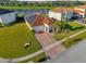 Single-Gathering home with solar panels and a brick driveway at 1651 Kingfisher Ct, Kissimmee, FL 34746