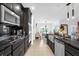 Modern kitchen, dark cabinetry, stainless steel appliances, and granite countertops at 1651 Kingfisher Ct, Kissimmee, FL 34746