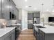 Modern kitchen with gray cabinets and a large island at 3529 Banana Shrub Blvd, Clermont, FL 34711