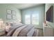 Cozy bedroom with gray bedding and a mounted TV at 3961 Ambrose Ave, Kissimmee, FL 34746