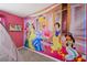 Princess themed bedroom with mural and TV at 4428 Kaipo Rd, Davenport, FL 33897