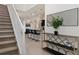 Bright entryway with staircase, console table, and mirror at 4428 Kaipo Rd, Davenport, FL 33897