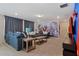 Fun game room with a superhero mural and comfy seating at 4428 Kaipo Rd, Davenport, FL 33897